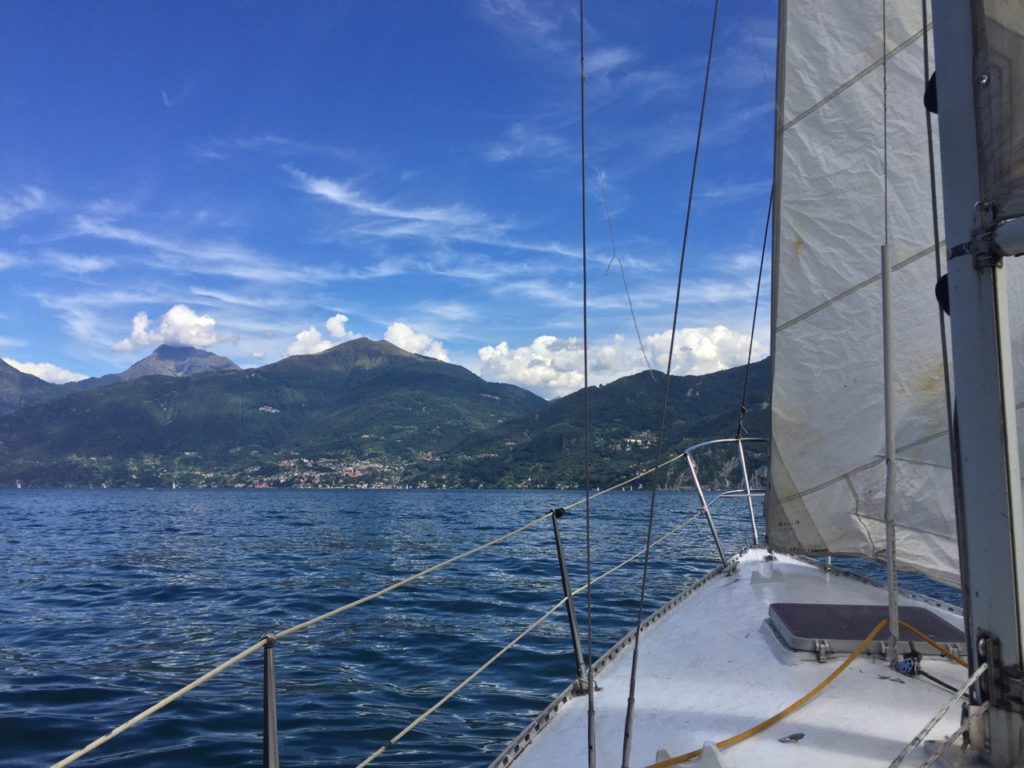 sailing boat sailing in Lake Como towards  Varenna